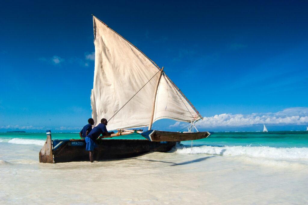Zanzibar Island beach with traditional dhow boat"